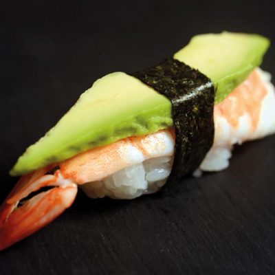 Nigiri with boiled shrimp and a slice of avocado on top